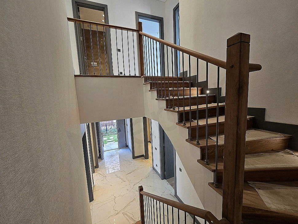 Interior view of a spacious and bright villa corridor.