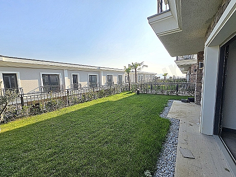 Image of a luxurious villa with a spacious garden.