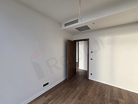 Modernly designed bedroom interior with double bed, bedside tables, and stylish lighting