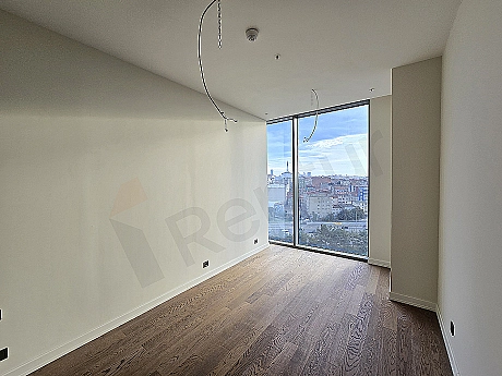 Interior view of a modernly designed bedroom. Details include a double bed, dresser, mirror, and decorative lighting.
