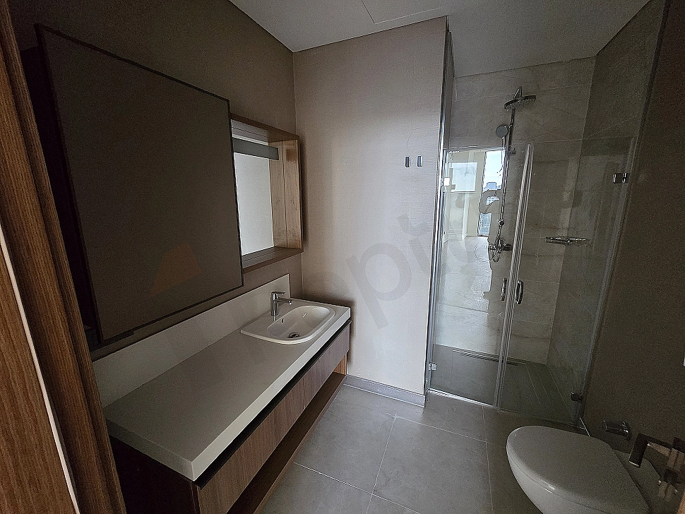Modern designed, bright and spacious bathroom interior. White ceramics, large shower area, and stylish sink.