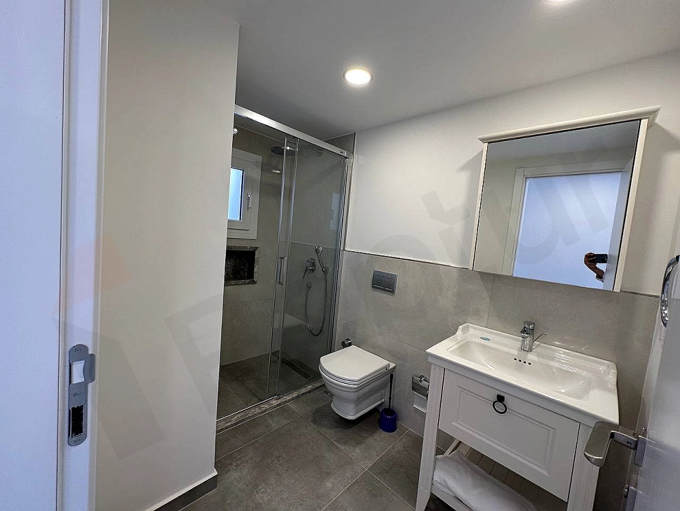 A clean and bright bathroom interior with modern design, stylish sanitary ware and fixtures.