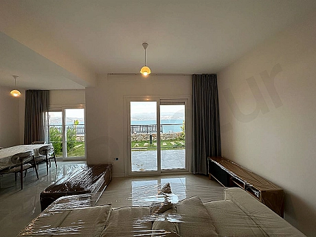 A spacious and bright living room furnished with modern furniture in Bodrum.