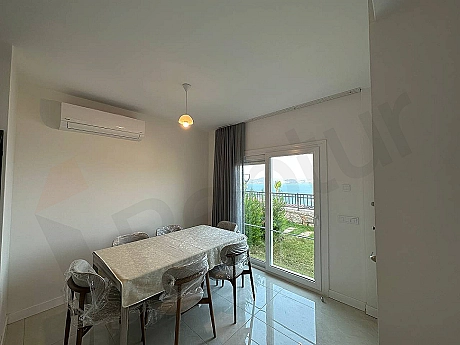 A stylish dining room area decorated with a modern dining table and comfortable chairs.