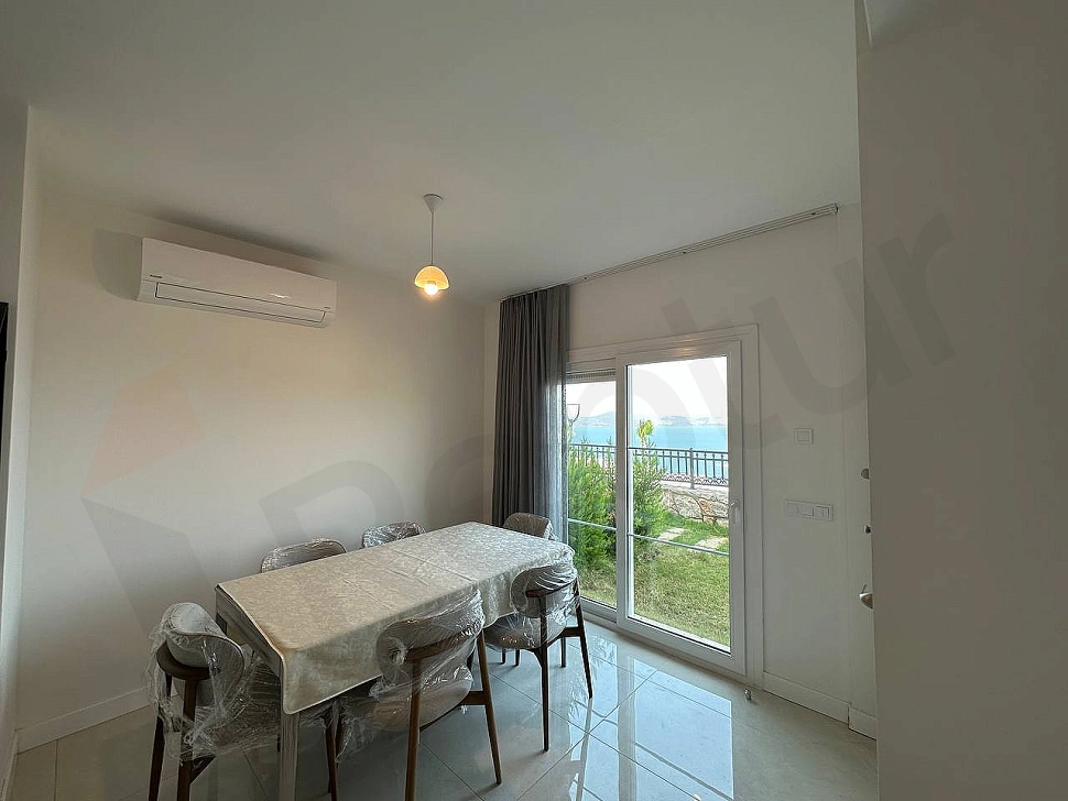 A stylish dining room area decorated with a modern dining table and comfortable chairs.