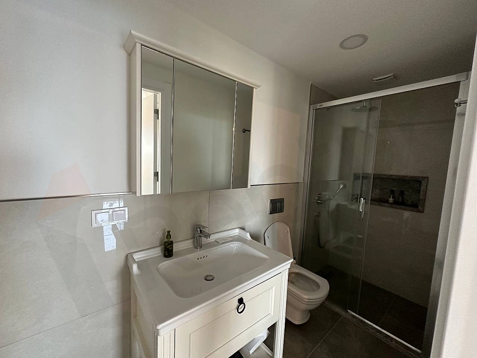 Interior view of a modern bathroom with stylish tiles and contemporary sanitary ware.