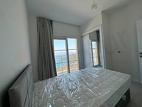 A spacious and bright furnished bedroom decorated with modern furniture.