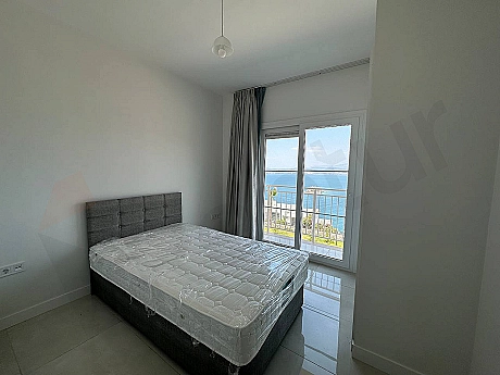 View of a spacious and bright bedroom decorated with modern furniture.