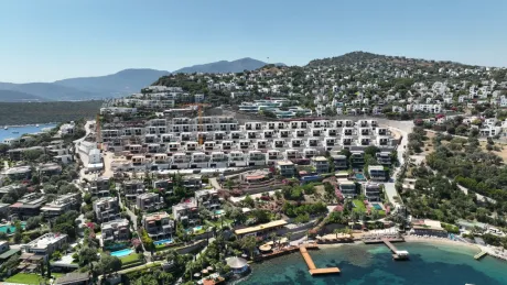 Bird's-eye view of a luxury residential project layout and panoramic sea view from the water.