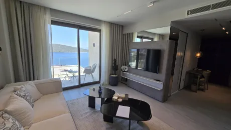 Spacious and modern living room area of a detached house with large windows.