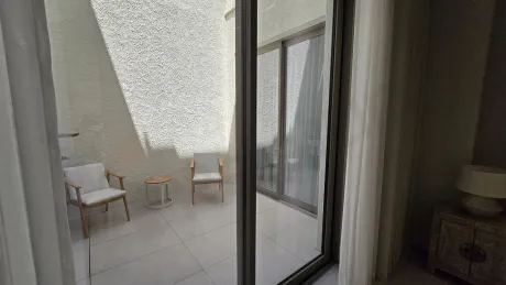 Spacious and modernly designed open terrace area of a detached house with a sea view.