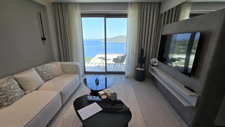 Spacious and bright living room area of a modern villa with large windows.
