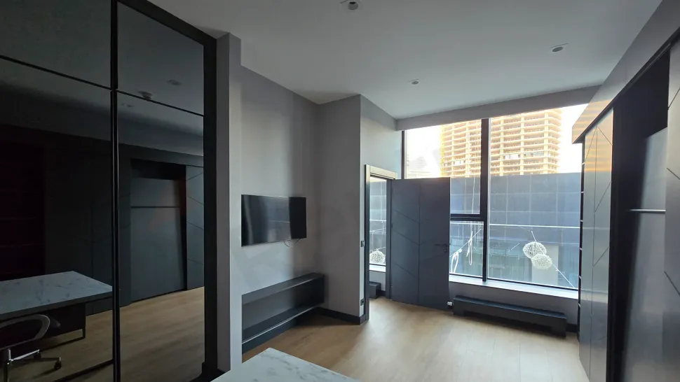 Spacious and bright furnished living room decorated with modern furniture.