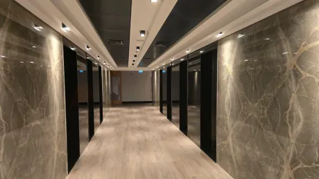 A modern and brightly lit hallway and entrance view of a residence apartment.