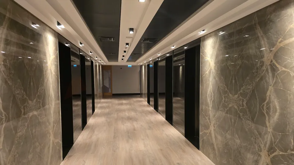 A modern and brightly lit hallway and entrance view of a residence apartment.