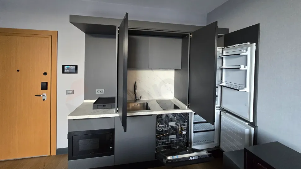 Detailed view of the kitchen area in a modern and fully furnished 1+1 apartment.