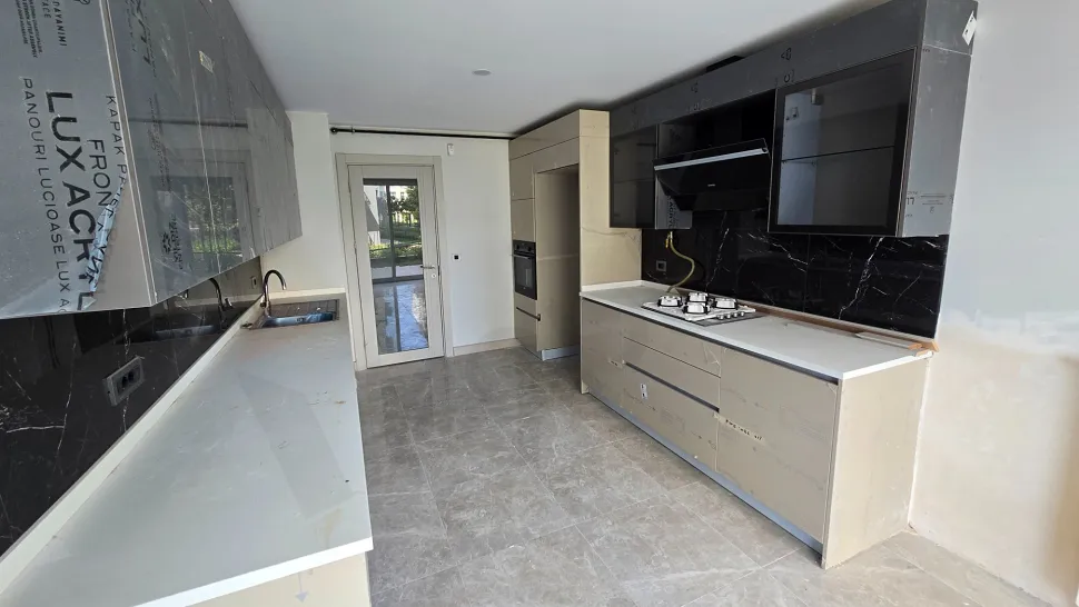 Modernly designed, spacious and bright kitchen area.