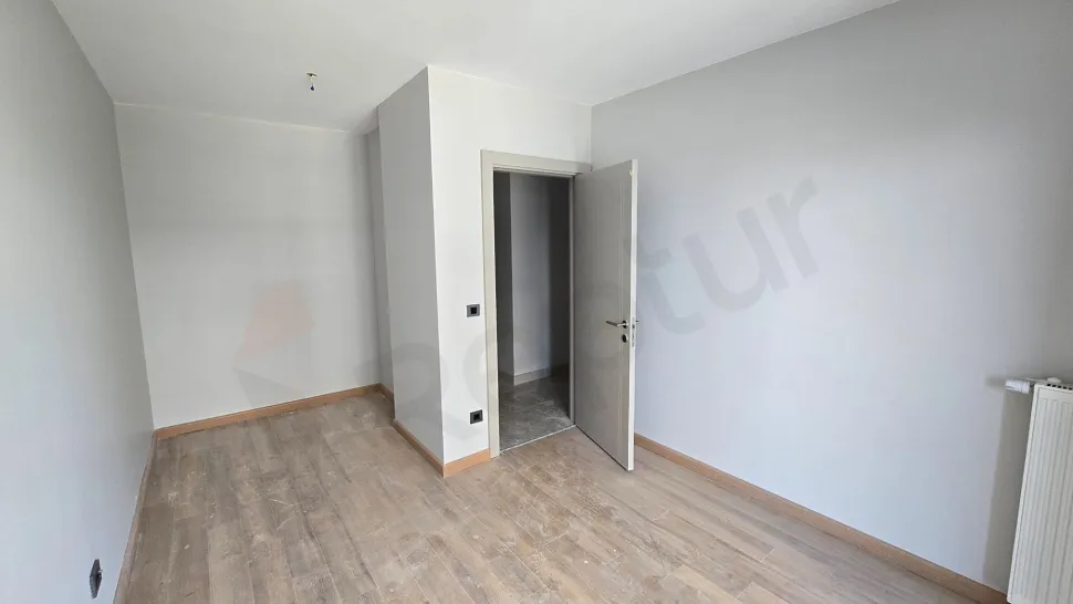 Spacious, sunlit, and modern bedroom area of a 4+1 duplex apartment for sale in Beylikdüzü.