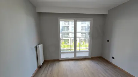 Interior view of an empty bedroom with large windows and modern design in Beylikdüzü.