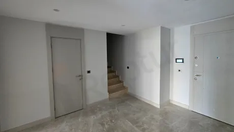 Elegant indoor staircase design within a modern duplex apartment interior.
