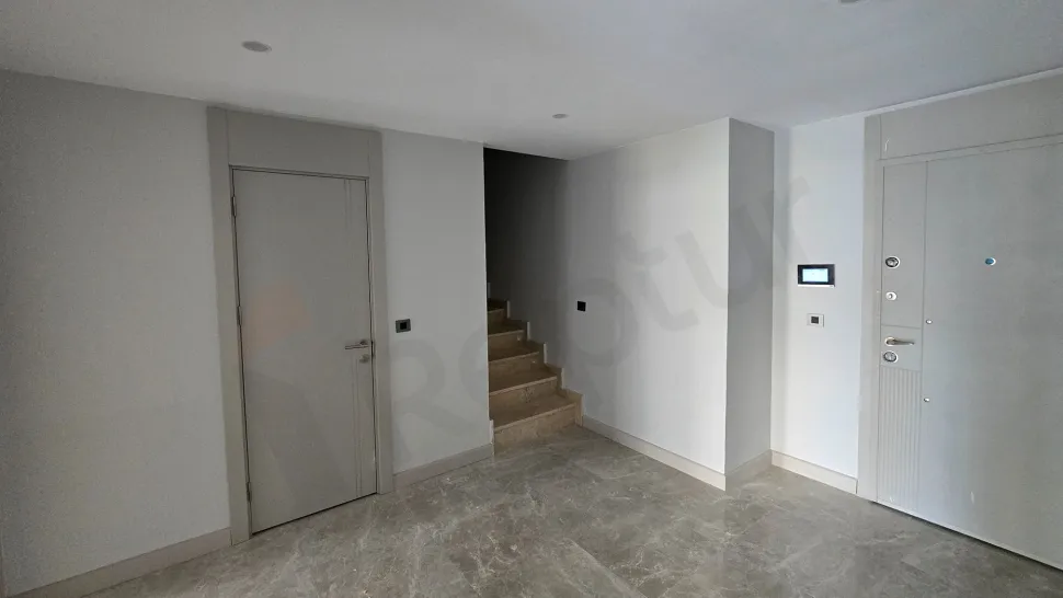 Elegant indoor staircase design within a modern duplex apartment interior.