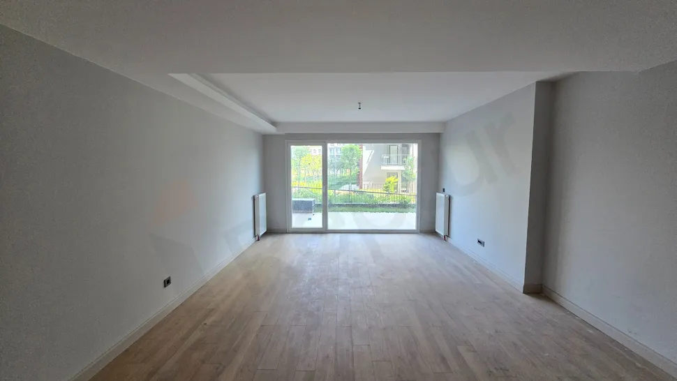 Modern living room area with large windows and a city view.