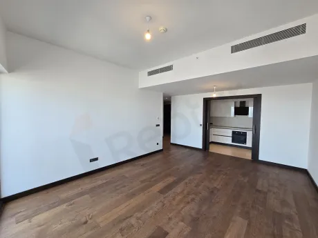 Interior view of a modern living room with large windows.