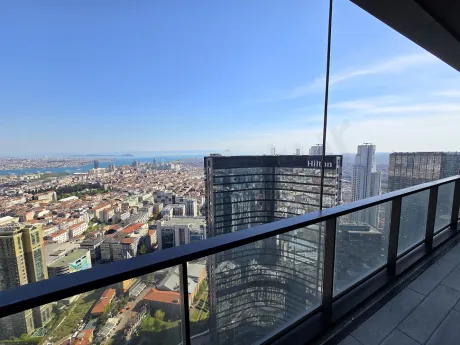 Spacious balcony of a modern apartment with a city view.