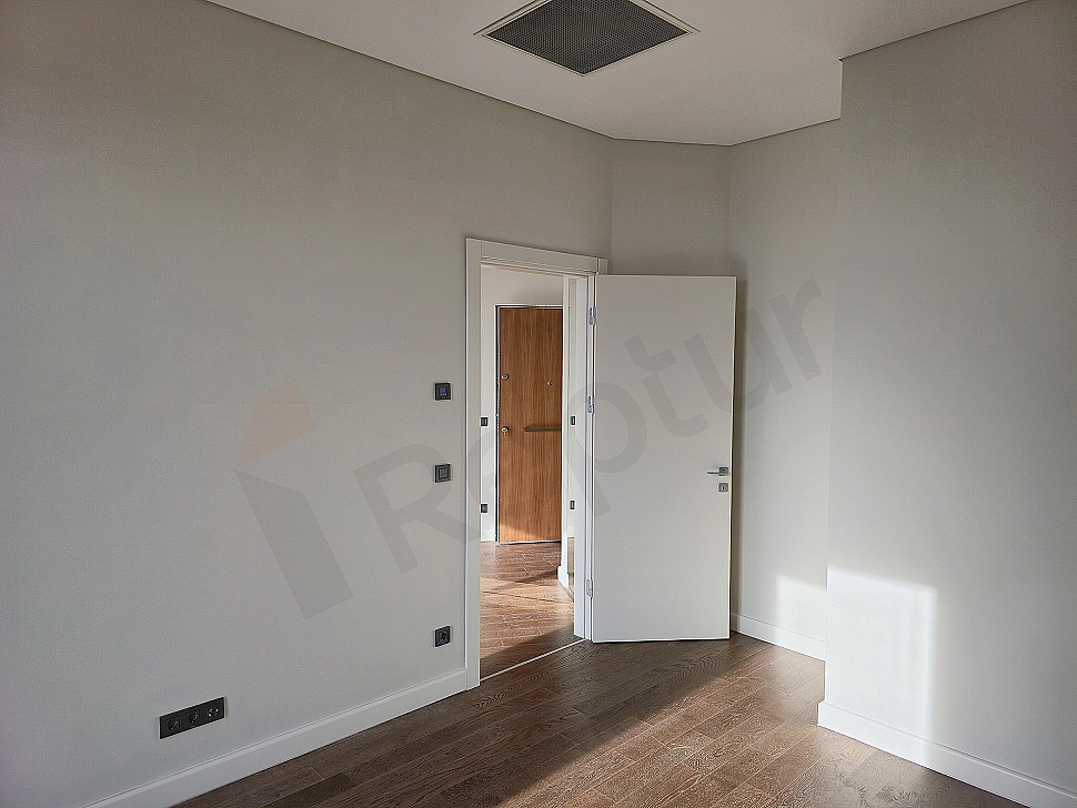 Modern bedroom interior with wooden floor, white walls, double bed and bedside tables