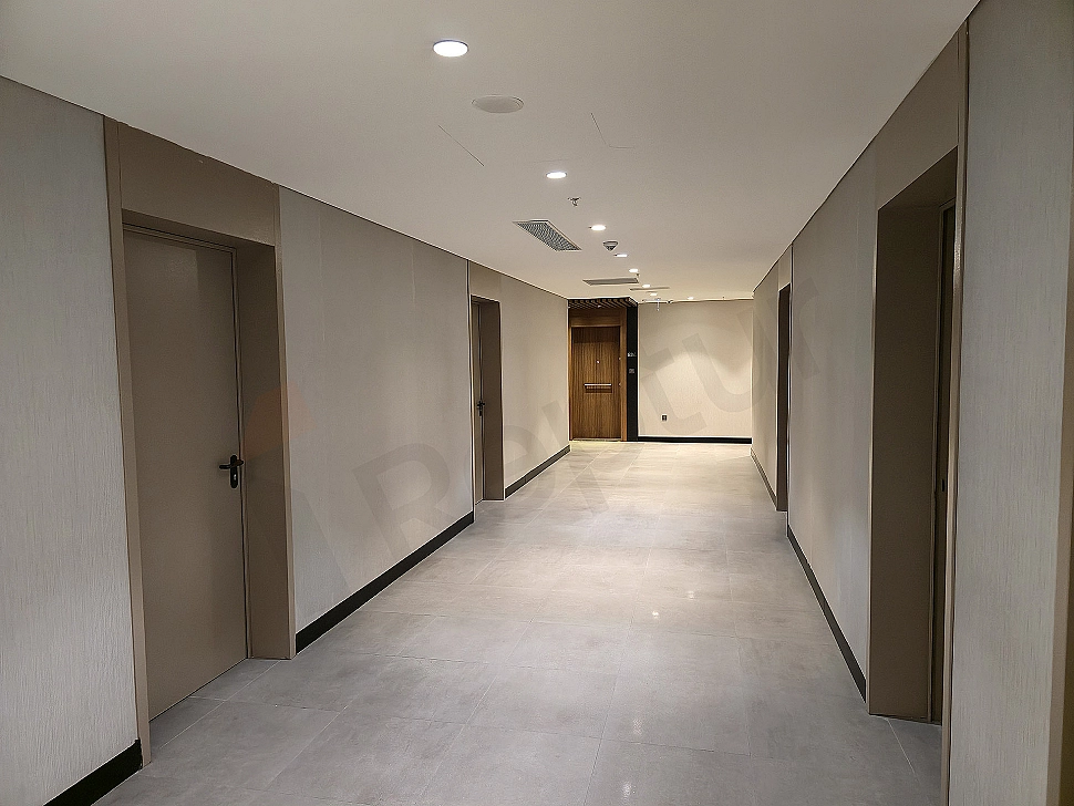 Image of a wide and spacious corridor with modern lighting.