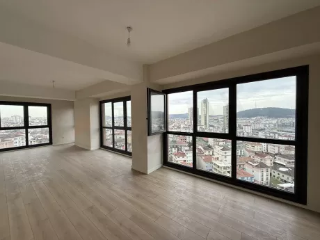 Empty living room area with large windows, spacious and modern architecture.