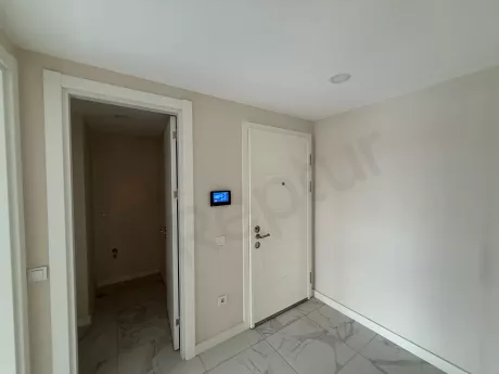 View of the entrance door and hallway area of a modern apartment.