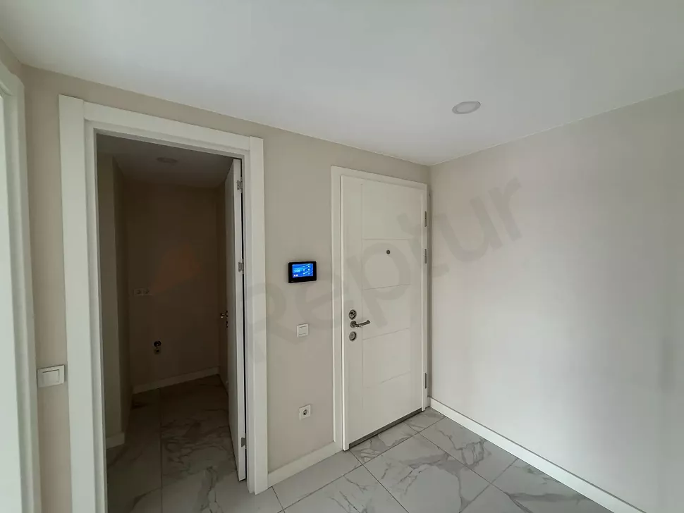 View of the entrance door and hallway area of a modern apartment.