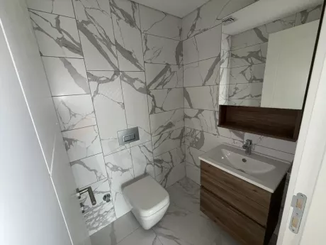 A spacious apartment bathroom with a modern and stylish design.