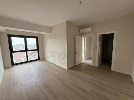 Bright interior view of a modern and spacious bedroom.