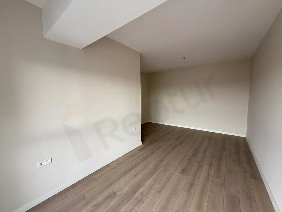 Bright interior view of a modern and spacious bedroom.