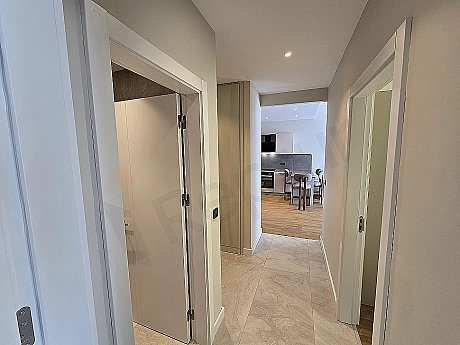Interior view of a furnished apartment corridor.