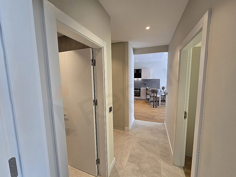 Interior view of a furnished apartment corridor.
