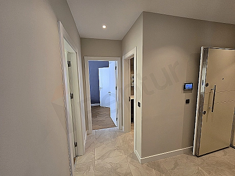 Interior view of a furnished apartment corridor.