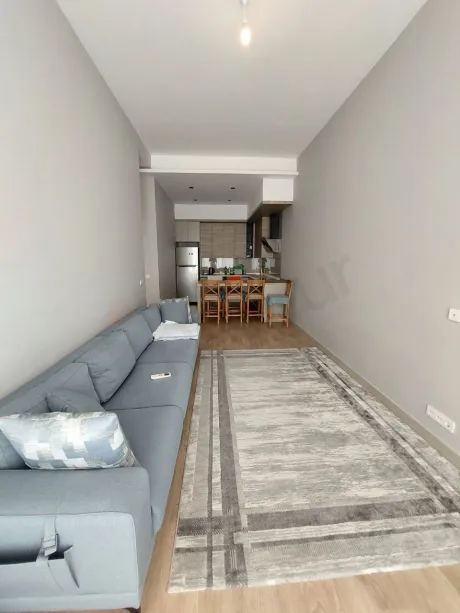 Spacious and bright living room area of a modern apartment with large windows.