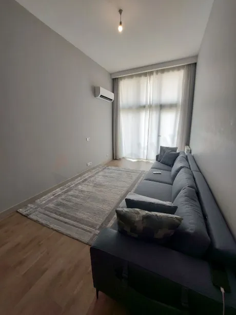 Spacious and bright living room area of a modern apartment.