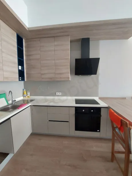 Interior view of a modern and spacious apartment kitchen.