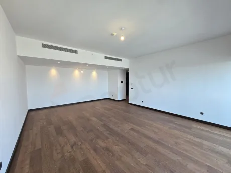 A spacious and bright living room with large windows and modern architecture in Sisli.