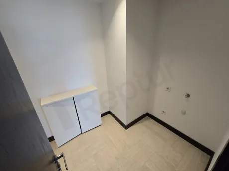 Spacious and organized storage unit area inside a modern luxury residence building.