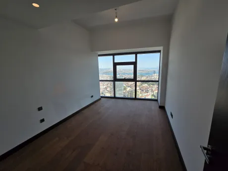 Spacious and modern residence bedroom interior with large windows.