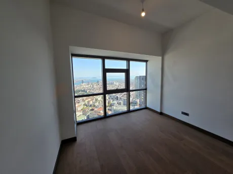 Interior view of a spacious and modernly designed bedroom with natural light.