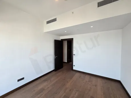 Spacious, bright and modern bedroom design with large windows.
