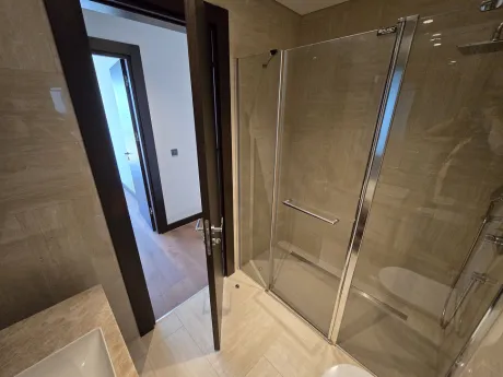 Modern bathroom design with stylish ceramic tiles and vanity area.