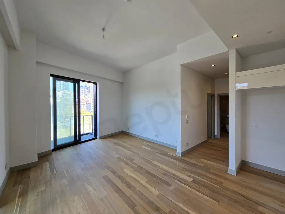View of a bright and modern living room with large windows.