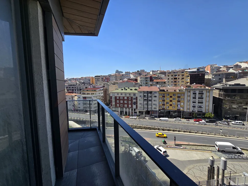 Spacious balcony of a modern residence apartment in Sisli with a panoramic city view.